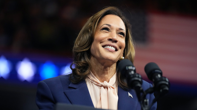 Kamala Harris smiling behind podium