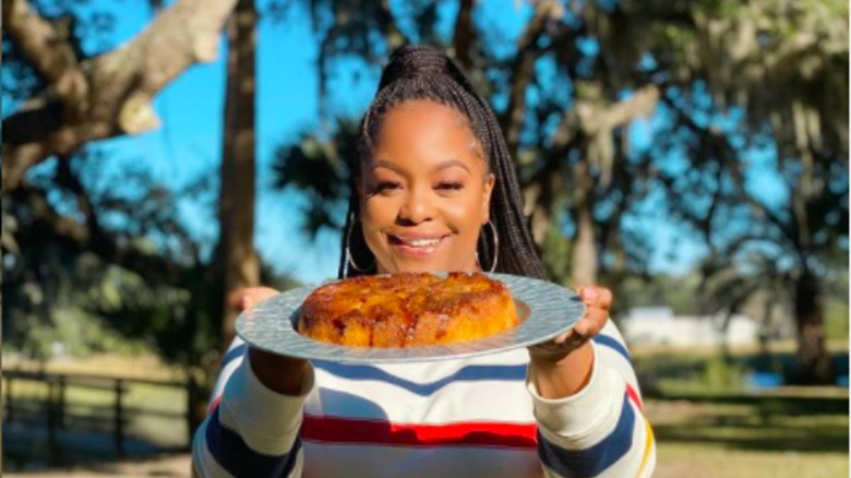 Chef Brown smiling with her cake