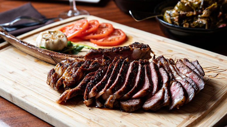 A carved steak on a cutting board at Hall's Chophouse