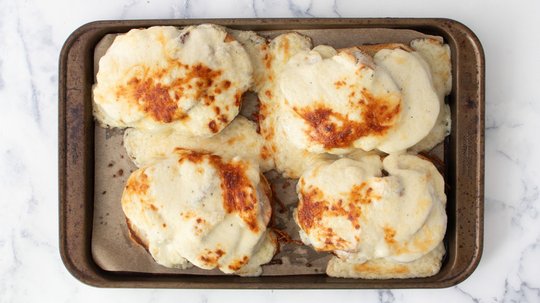 Broiled cheese sandwiches on baking sheet