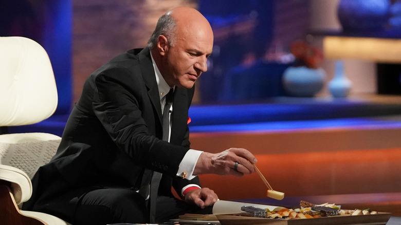 Kevin O'Leary trying cheese from charcuterie board