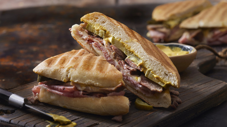 Cuban sandwich cut in half on dark background