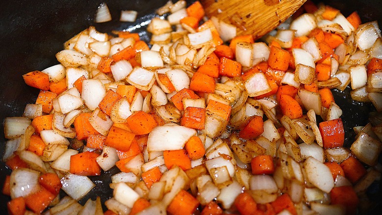 onions and carrots in pan