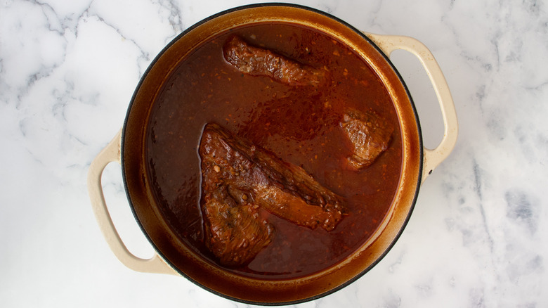 brisket braising in bulgogi sauce in dutch oven