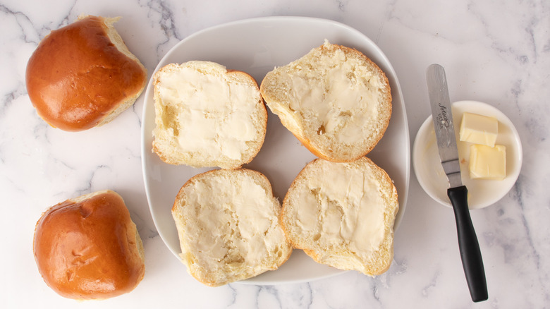 buttered bread rolls on plate