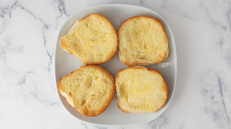 toasted buttered bread rolls on plate