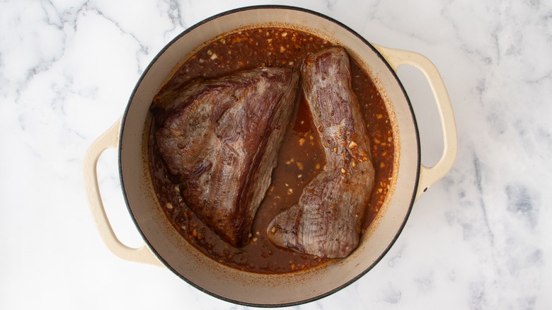 brisket meat sitting in sauce