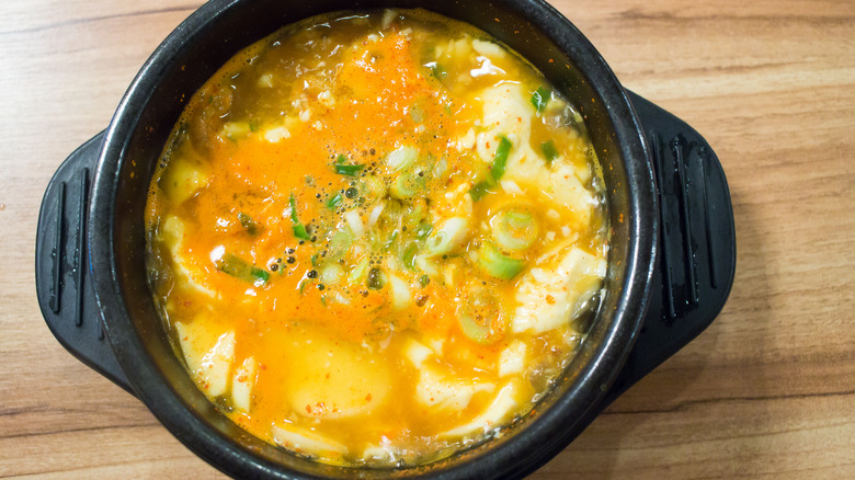 Sundubu jjigae in black bowl