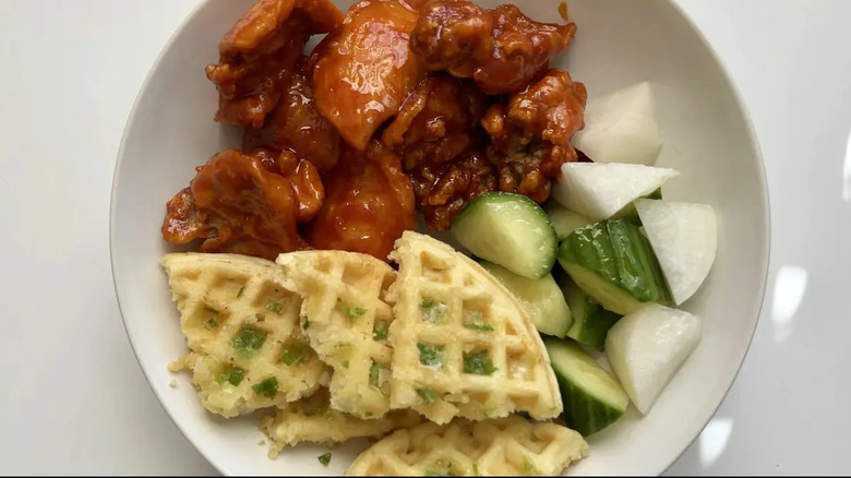 Korean fried chicken, vegetables, and waffles in bowl