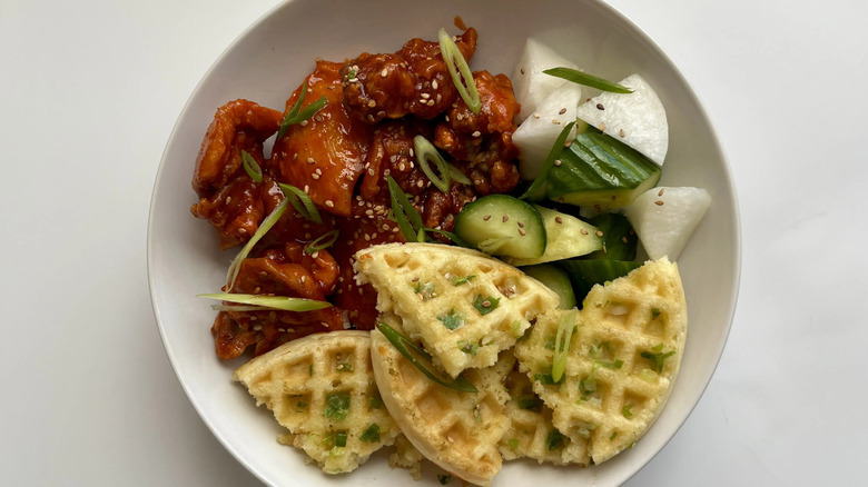 Korean fried chicken, vegetables, and waffles in bowl