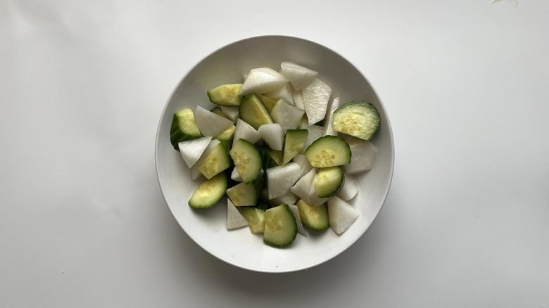 Chopped cucumber and radish in white bowl