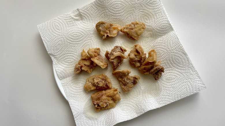 Fried chicken pieces on paper towels