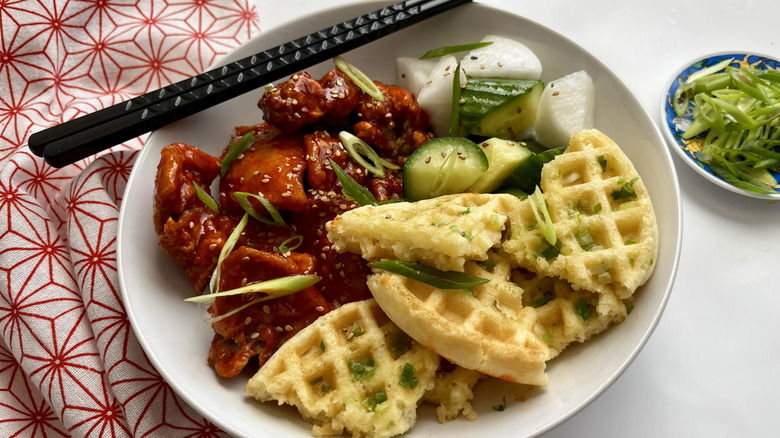 Korean fried chicken, vegetables, and waffles in bowl