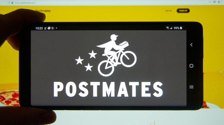 Postmates logo on cell phone