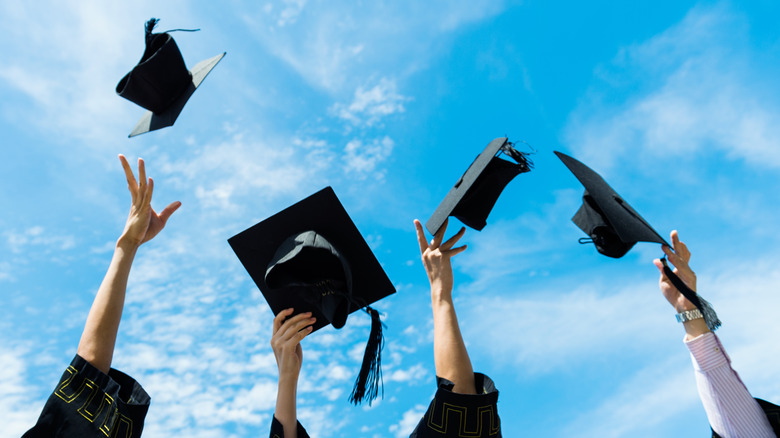 Graduation caps flying through the air