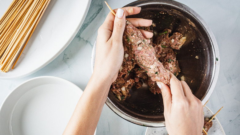 arranging lamb kofta kebab on skewer