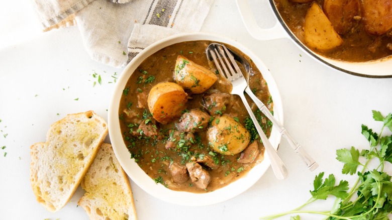 stew in bowl with bread