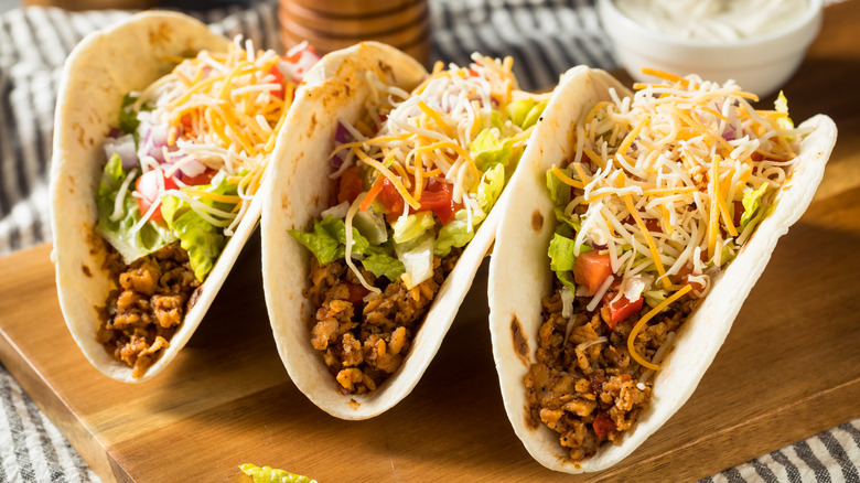 3 tacos with cheese and toppings