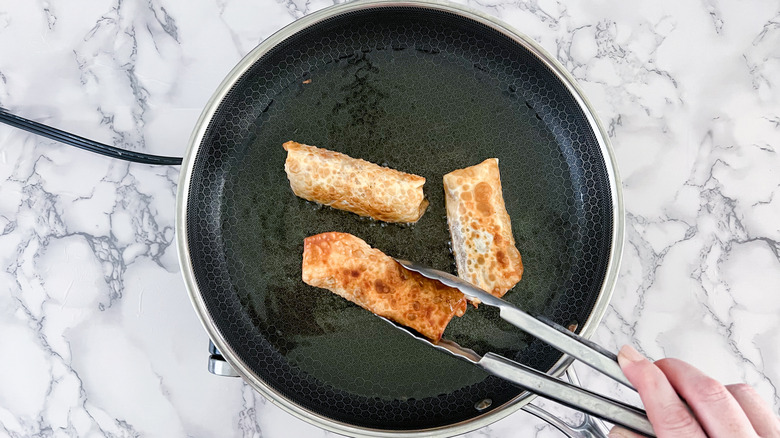 frying egg rolls in skillet