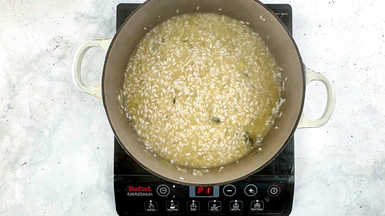 risotto with stock in pan