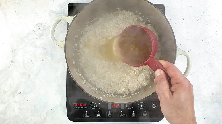 adding stock to risotto