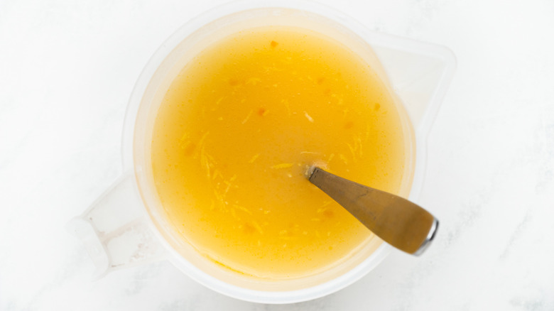 stock and spoon in clear bowl