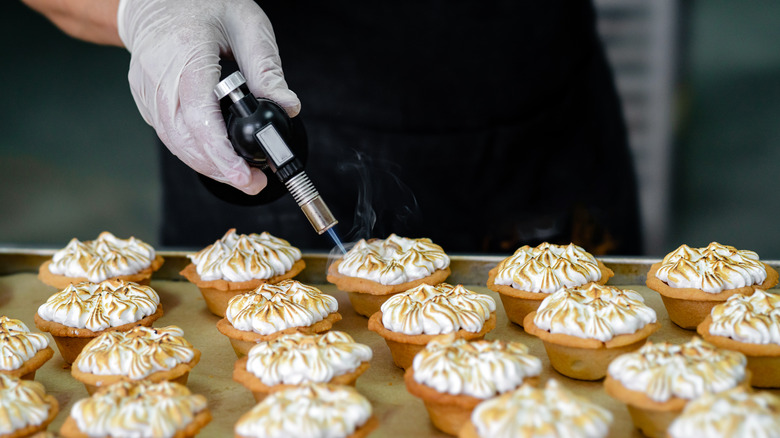 Blowtorching mini meringue pies