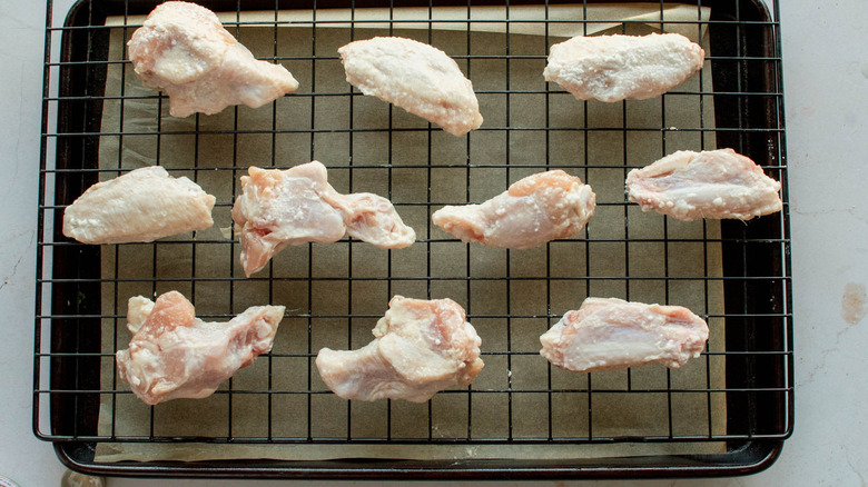 raw chicken wings on rack