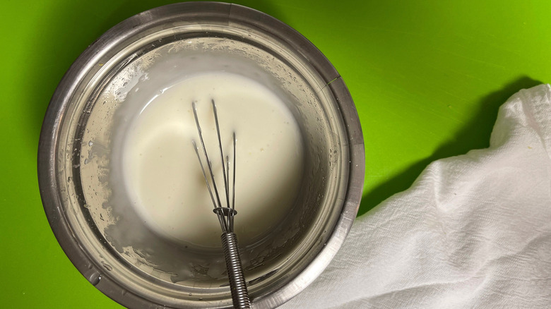 Icing with small whisk in bowl