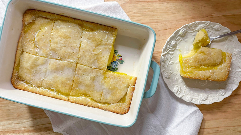 Lemon Omaha cake in baking dish with slice on plate