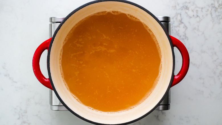 chicken broth simmering in pot