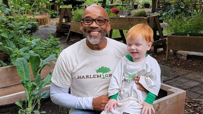 Tony Hillery in garden with child