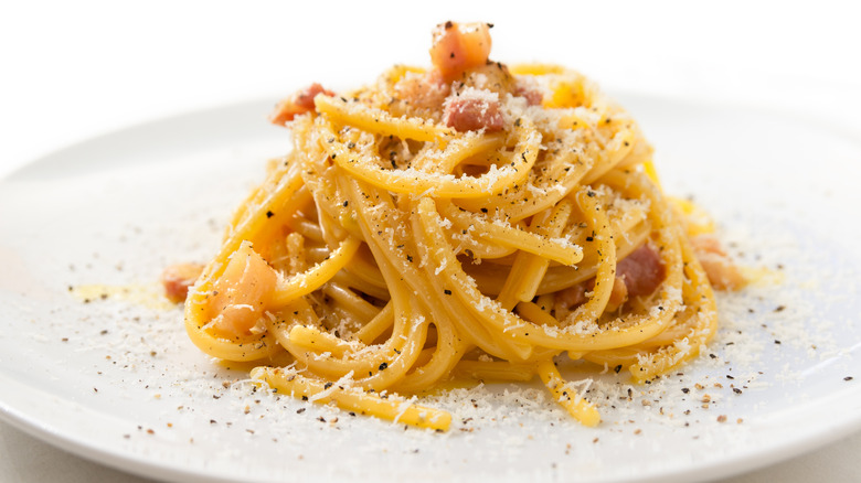 pasta carbonara on a plate with parmesan