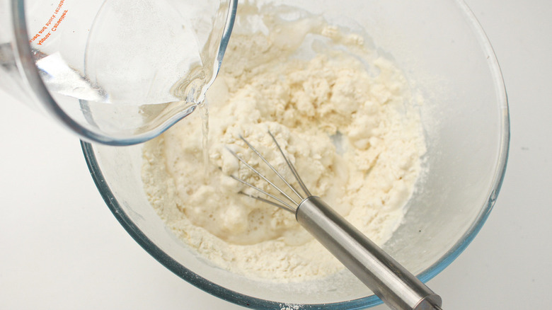 pouring seltzer into batter