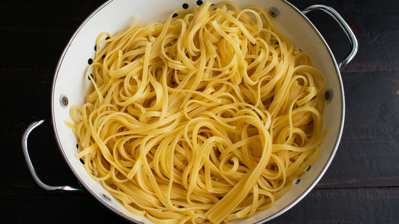 Cooked linguine pasta in a colander