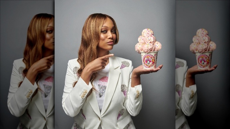 Tyra banks posing with cup of smize ice cream