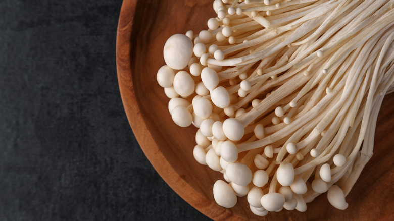 White enoki in a wood bowl