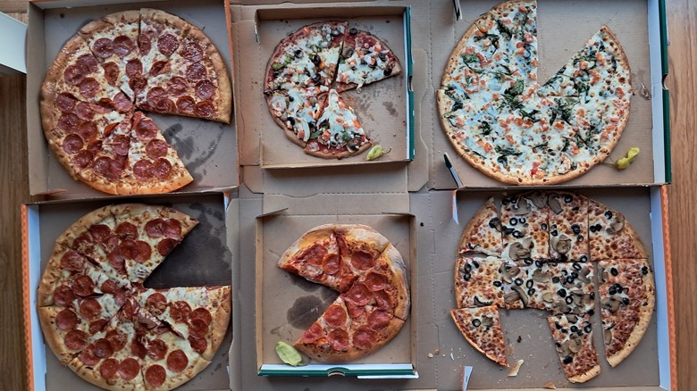Six pizzas missing a slice