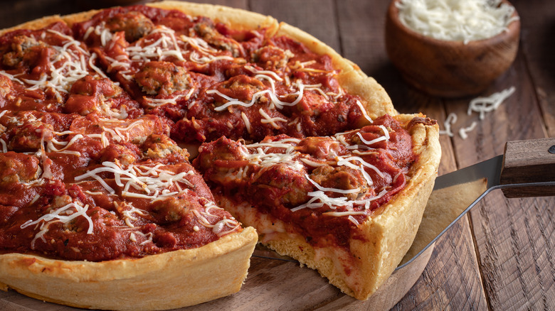 deep dish pizza being served