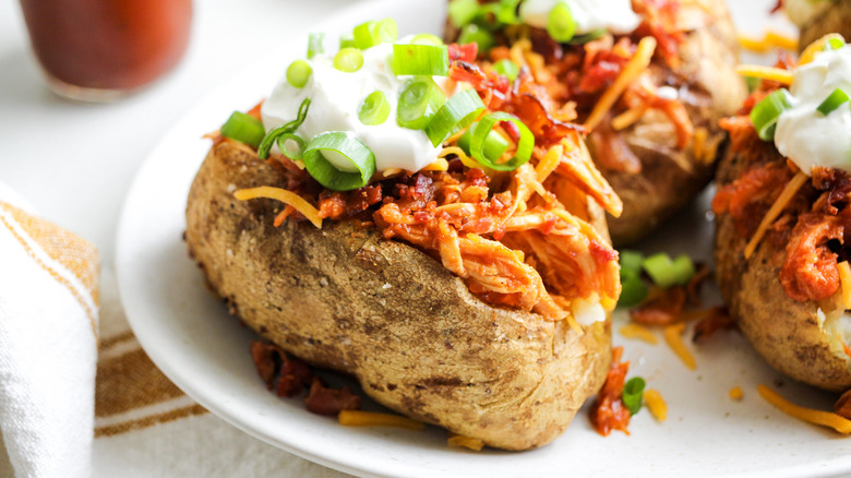 loaded chicken bbq baked potatoes on plate