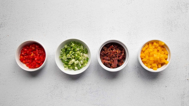 chopped vegetables and bacon in separate bowls