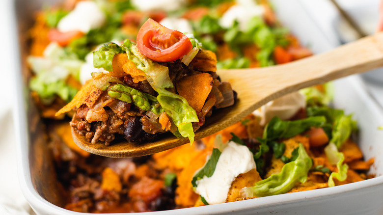 taco casserole scooped on wooden spoon