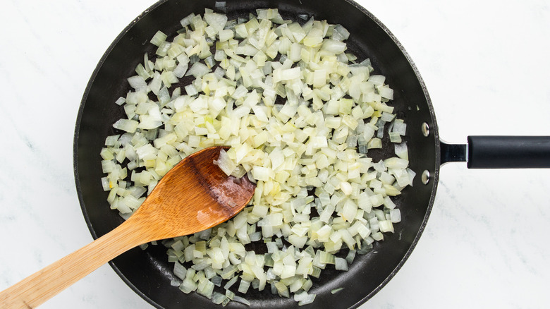 Diced onion frying in pan