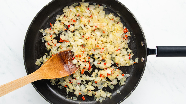 Onion, garlic and chile frying in pan