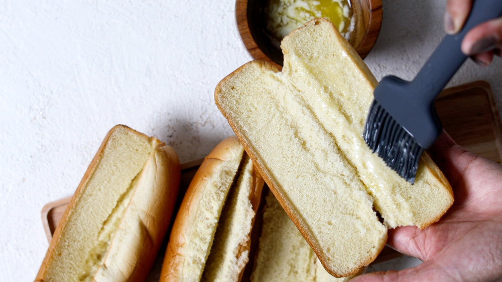 prepping buns to toast with butter