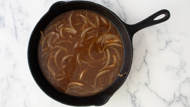 onions and broth in skillet