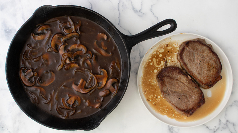 saucy mushrooms next to steaks