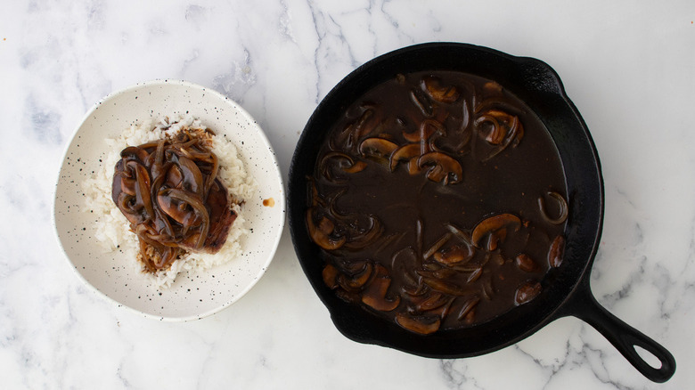 rice, steak, gravy on plate