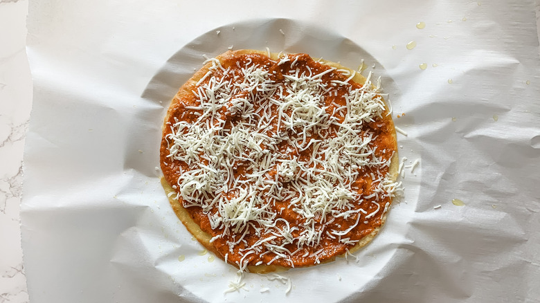 tortilla pizza with sauce and cheese 