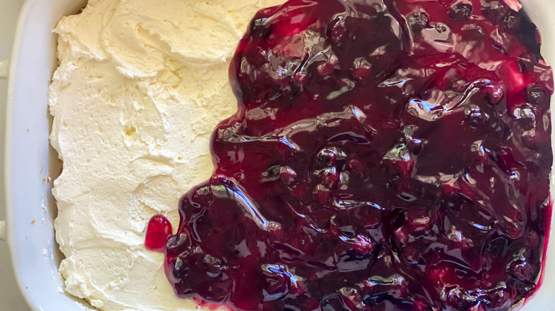 Spreading blueberry pie filling out over Cool Whip